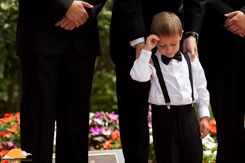 ring-bearer in suspenders and bow-tie ringbearer in suspenders and bowtie in garden
