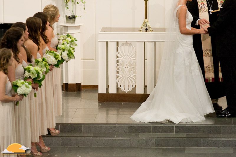 bridesmaids at altar with bride and groom bridesmaids in tan dresses