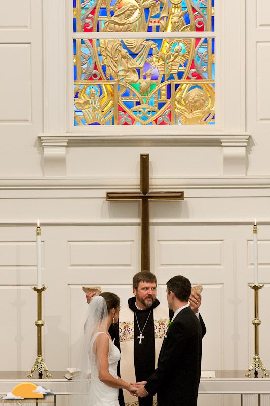 communion during wedding ceremony breaking bread with bride and groom