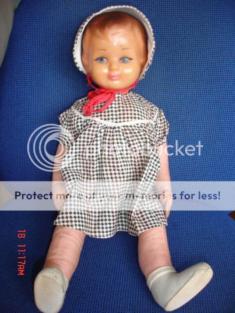 This is an antique doll with rubber head,straw body and cotton hands 